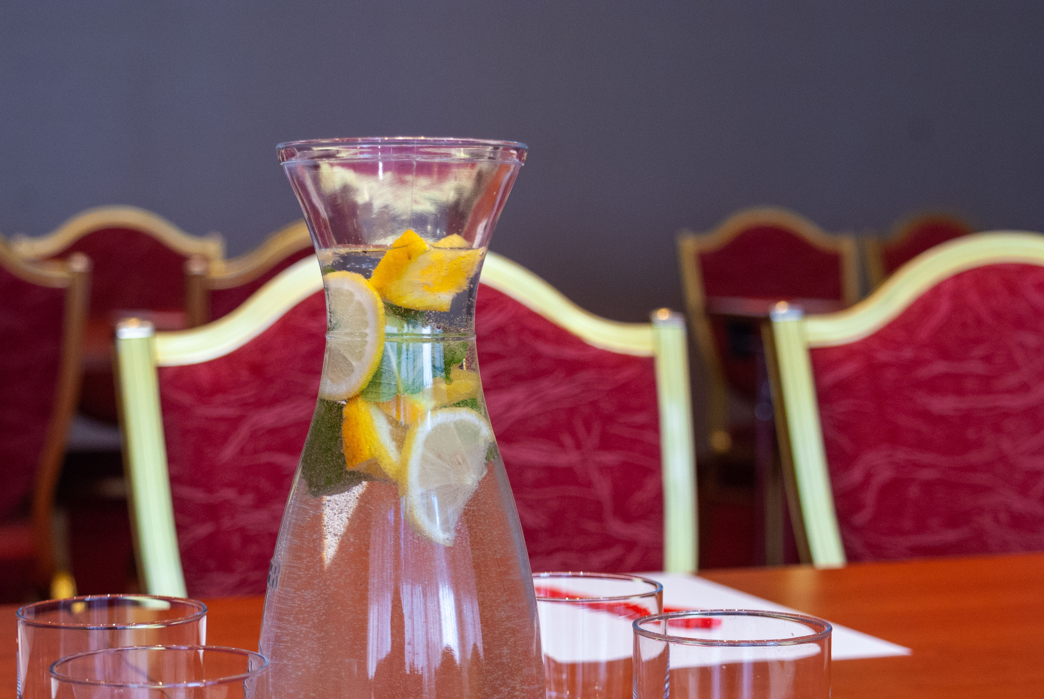 Real Estate Photography - Conference Room Red Chairs Drink Lemon